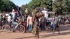 Displaced people from the region of Chiure, Mozambique, gather on Oct. 24, 2022, around a flat bed truck carrying mattresses and other household items salvaged by fleeing residents after a wave of incursions by armed groups. 