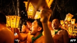 Men carry lanterns as they walk to a river to cleanse their bodies during the Sominsai Festival at Kokuseki-ji Temple in Oshu, Iwate Prefecture, Japan, Feb. 17, 2024.