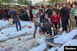 Bodies of Palestinians killed in Israeli strikes on houses in Jabalia refugee camp, lie at a hospital in the northern Gaza Strip, Oct. 31, 2023.