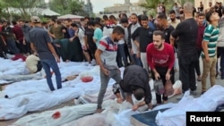 Bodies of Palestinians killed in Israeli strikes on houses at Jabalia refugee camp are gathered after being brought to a hospital in the northern Gaza Strip, Oct. 31, 2023.