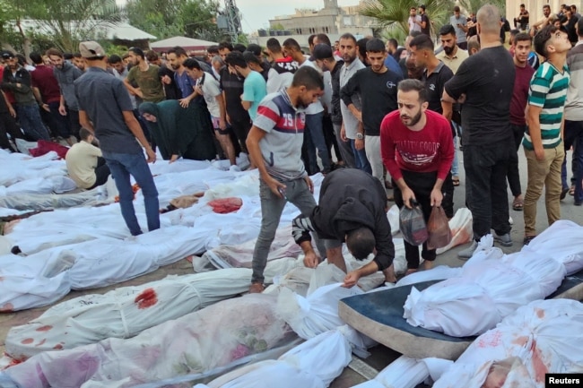 Bodies of Palestinians killed in Israeli strikes on houses in Jabalia refugee camp, lie at a hospital in the northern Gaza Strip, Oct. 31, 2023.