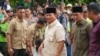 Prabowo Subianto, center, arrives for a visit to his father's grave in Jakarta, Indonesia, Feb. 15, 2024. The ex-general and current defense minister looks set to be the country's next president, according to unofficial vote tallies.