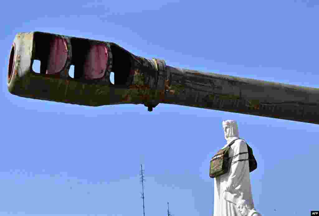 The Princess Olga monument is seen in a dummy bulletproof vest with a sign reading, &quot;She needs armour,&quot; to draw attention to the need of armor designed specifically for women, at an open-air exhibition of destroyed Russian armored vehicles in Kyiv, Ukraine.