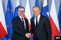 Perdana Menteri Polandia Donald Tusk (kanan) menyambut Perdana Menteri Finlandia Petteri Orpo di kantor Perdana Menteri Polandia di Warsawa, Polandia, 16 Februari 2024. (Sergei GAPON / AFP)