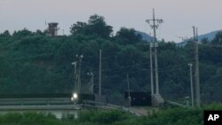 A North Korean military guard post, left top, is seen from Paju, South Korea, near the border with North Korea, July 18, 2023.