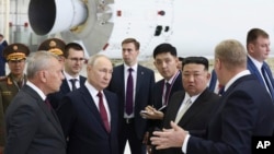 FILE - Russian President Vladimir Putin, second left in front, and North Korea's leader Kim Jong Un, second right in front, examine a rocket assembly hangar at the Vostochny cosmodrome outside Tsiolkovsky, Russia, Sept. 13, 2023. 