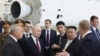 FILE - Russian President Vladimir Putin, second from left in front, and North Korea's leader Kim Jong Un, second from right in front, examine a rocket assembly hangar at the Vostochny cosmodrome outside Tsiolkovsky, Russia, Sept. 13, 2023. 