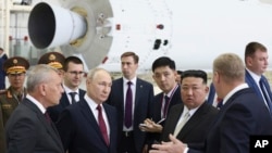FILE - Russian President Vladimir Putin, second from left in front, and North Korea's leader Kim Jong Un, second from right in front, examine a rocket assembly hangar at the Vostochny cosmodrome outside Tsiolkovsky, Russia, Sept. 13, 2023. 