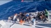 Dalam gambar yang diambil dari video yang dirilis oleh Penjaga Pantai Italia pada Kamis, 11 April 2024, sebuah perahu berisi migran sedang mendekat dalam operasi penyelamatan di lepas pulau Lampedusa di Laut Mediterania.(Guardia Costiera via AP, HO)