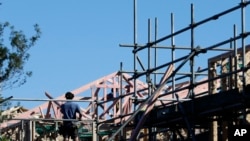 FILE - Builders work on a construction site in Christchurch, New Zealand, April 28, 2020.