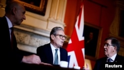 Britain's Prime Minister Keir Starmer (C) meets with Britain's Defense Secretary John Healey (L) and Member of the House of Lords George Robertson (R) at 10 Downing Street, in London, on July 16, 2024. 