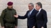 PLO Secretary General Hussein al-Sheikh, center, welcomes U.S. Secretary of State Antony Blinken, right, before his meeting with Palestinian President Mahmoud Abbas in the West Bank town of Ramallah, Feb. 7, 2024.