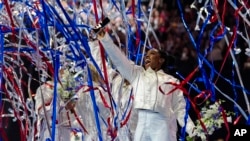 FILE - Simone Biles and the U.S. women celebrate as the 2024 team is named at the United States Gymnastics Olympic Trials in Minneapolis, June 30, 2024.