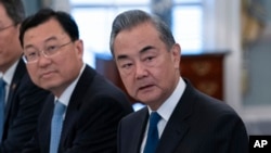 FILE - Chinese Foreign Minister Wang Yi, right, listens during a bilateral meeting at the State Department in Washington, Oct. 27, 2023.