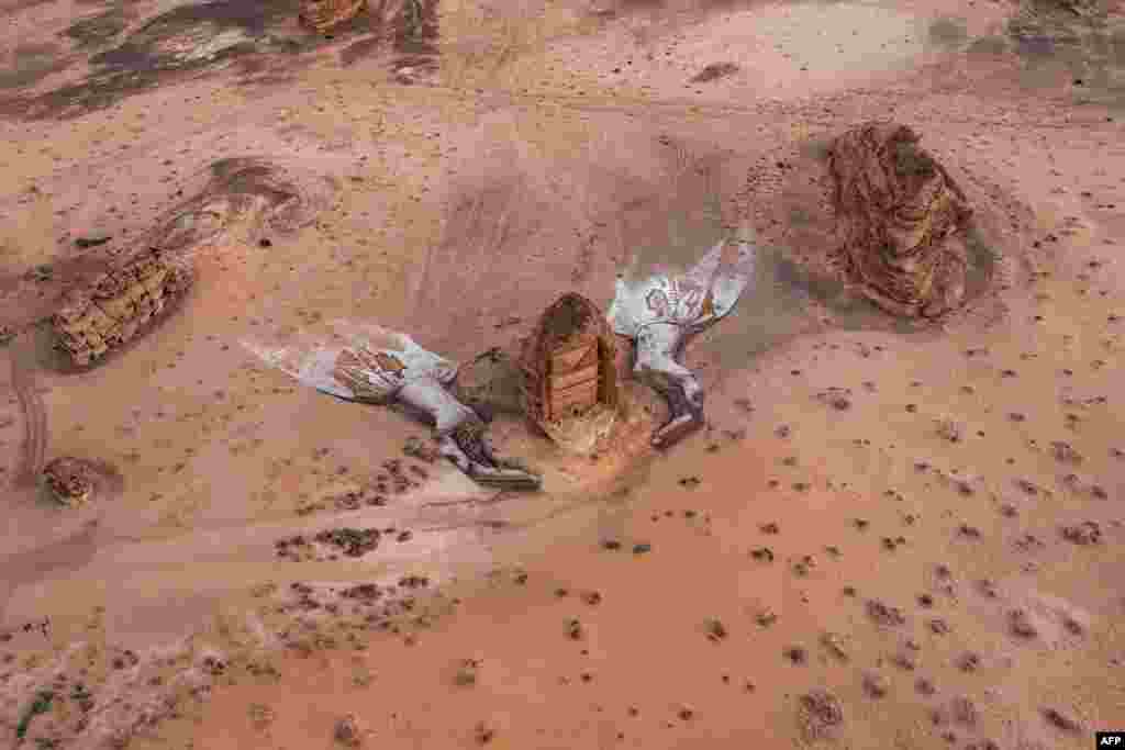 This picture released by the Royal Commission for AlUla shows an aerial view of an ephemeral art installation by American artist David Popa, in the shape of two protective hands, constructed around the Nabatean tomb of Lihyan, son of Kuza, at Hegra in northwestern Saudi Arabia.