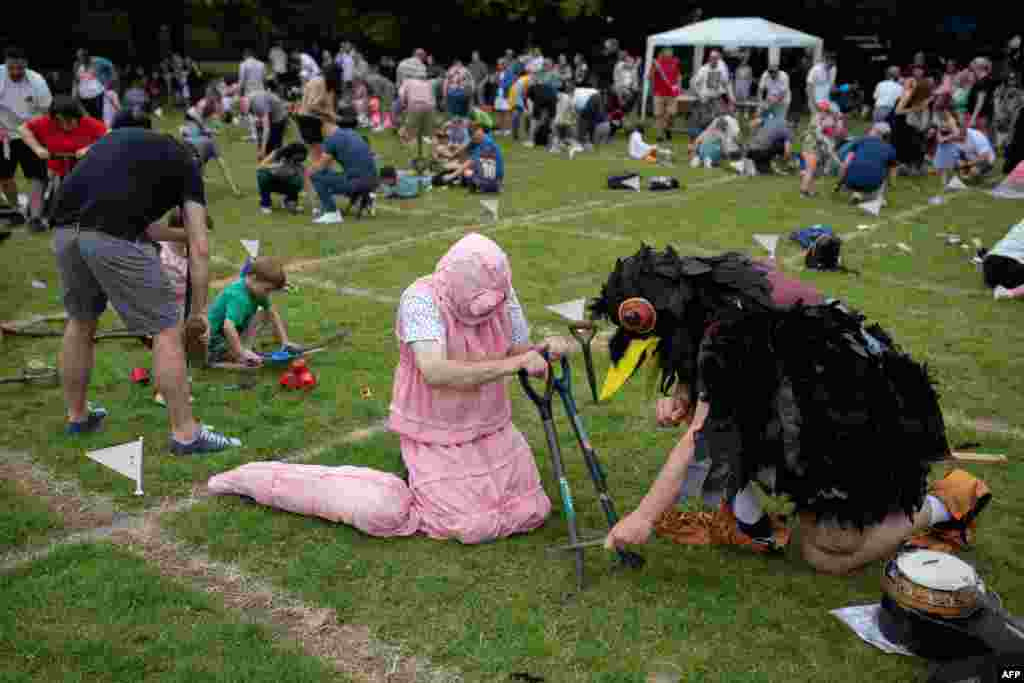 Chris White, dressed as a worm, and Andrew Feltham, dressed as a crow, compete in the annual World Worm Charming Championships held at Willaston Primary Academy in Willaston, near Nantwich, England, June 22, 2024.