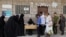 FILE - Beneficiaries of World Food Program assistance queue at a food distribution center amid exacerbating food shortages, in Sanaa, Yemen, July 18, 2023. 