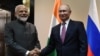 FILE - Russian President Vladimir Putin, right, shakes hands with Indian Prime Minister Narendra Modi before their meeting on the sidelines of the Shanghai Cooperation Organization (SCO) summit in Bishkek, Kyrgyzstan June 13, 2019. (Sputnik/Grigory Sysoyev/Kremlin)