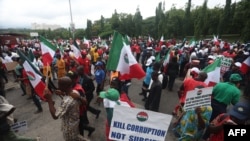 FILE - Workers from the two main workers unions — the Nigerian Labour Congress and the Trade Union Congress — march in Abuja on Aug. 2, 2023. The unions began an indefinite strike on Nov. 14, 2023, in response to the beating of a union leader and the cost-of-living crisis.