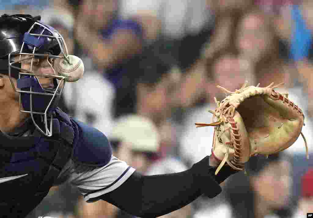 Cleveland Guardians catcher Bo Naylor keeps his eye on the ball as it is fouled off by Chicago Cubs&#39; Seiya Suzuki during the fourth inning of a baseball game, July 1, 2023, in Chicago.