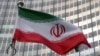 FILE — The Iranian flag flutters in front of the International Atomic Energy Agency organization's headquarters in Vienna, Austria, June 5, 2023.