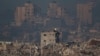 Bangunan-bangunan yang hancur tampak di Jalur Gaza, terlihat dari Israel selatan pada 20 November 2023. (AP Photo/Leo Correa)