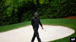 Tiger Woods walks on the 13th hole during the weather delayed third round of the Masters golf tournament at Augusta National Golf Club, Apr. 8, 2023, in Augusta, Ga. 