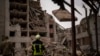 Firefighters work on a building that was partially destroyed in a Russian bombardment in Chernihiv, Ukraine, April 17, 2024. 