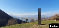 A metal monolith stands on the hills of Batca Doamnei, near Piatra Neamt, Romania, November 27, 2020. Picture taken November 27, 2020. (Inquam Photos/ziarpiatraneamt.ro via REUTERS)