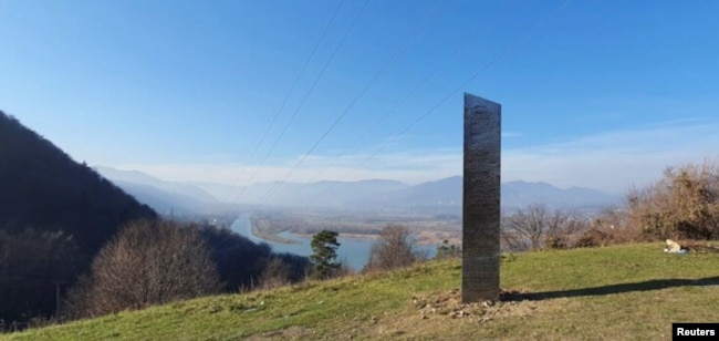 A metal monolith stands on the hills of Batca Doamnei, near Piatra Neamt, Romania, November 27, 2020. Picture taken November 27, 2020. (Inquam Photos/ziarpiatraneamt.ro via REUTERS)