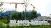 FILE - The Country Garden One World City project under construction is seen on the outskirts of Beijing, Aug. 17, 2023. Real estate difficulties in China have led to construction issues and labor protests. 