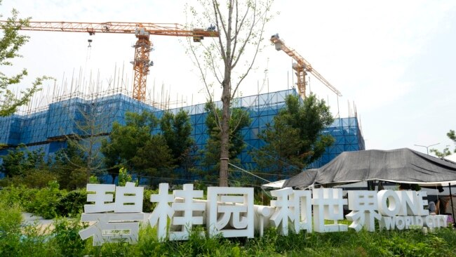 FILE - The Country Garden One World City project under construction is seen on the outskirts of Beijing, Aug. 17, 2023. Real estate difficulties in China have led to construction issues and labor protests.