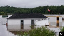 Buildings are seen in floodwater following a major rain event in Halifax, July 22, 2023. Intense thunderstorms dumped record amounts of rain across a wide swath of Nova Scotia.