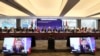 FILE - Azerbaidjan's COP29 lead negotiator Yalchin Rafiyev is seen on screens as he speaks during a high-level round table on COP energy and climate commitments organized by the International Energy Agency (IEA) at its headquarters in Paris, Feb. 20, 2024