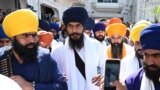 FILE - 'Waris Punjab De' chief Amritpal Singh (C) pays his respect at the Golden Temple in Amritsar on March 3, 2023. 