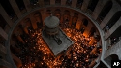Christian pilgrims hold candles in Holy Fire event at the Church of the Holy Sepulcher in Jerusalem, April 15, 2023.