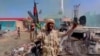 A member of the RSF forces walks around the destroyed Air Defence Forces command site in Khartoum, Sudan, in this screengrab obtained from a social media video on June 14, 2023. (RSF via Twitter/via Reuters)