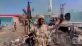 FILE: A member of the RSF forces walks around the destroyed Air Defence Forces command site in Khartoum, Sudan, in this screengrab obtained from a social media video on June 14, 2023. (RSF via Twitter/via Reuters)