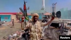 FILE: A member of the RSF forces walks around the destroyed Air Defence Forces command site in Khartoum, Sudan, in this screengrab obtained from a social media video on June 14, 2023. (RSF via Twitter/via Reuters)
