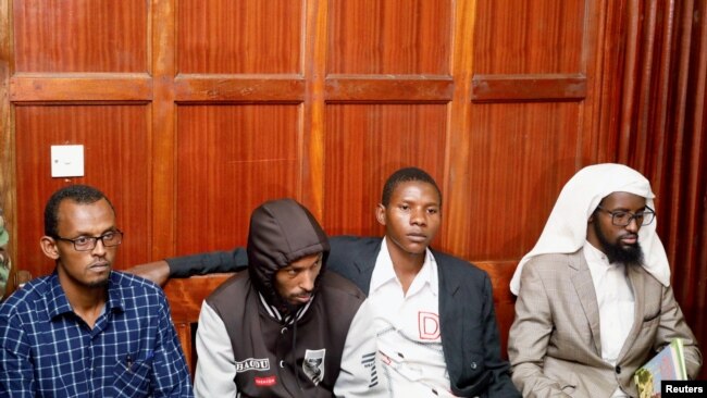 FILE - Suspects Hassan Edin Hassan, Mohamed Abdi Abikar, Rashid Charles Mberesero and Sahal Diriye sit in the dock as they wait for the verdict where they were charged with helping those who carried out the attack on Garissa University, June 19, 2019.