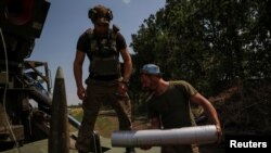 Ukrainian servicemen prepare to fire a 2S22 Bohdana self-propelled howitzer toward Russian troops at a position near Bakhmut in Donetsk region, Ukraine, July 5, 2023.