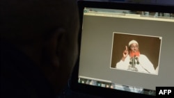 FILE - A man looks at a computer screen displaying an image of Somali-born cleric and Islamic State-Somalia leader Abdulqadir Mumin, in Nairobi, Kenya, Sept. 1, 2016. Mumin was targeted in an airstrike late last month, according to U.S. officials.
