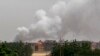 Smoke billows behind buildings from a reported fire in Khartoum, on June 5, 2023, as fighting continues between two warring generals.
