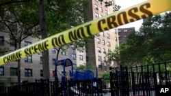 FILE - Police tape blocks the scene of a fatal shooting in Manhattan, New York, July 9, 2012.