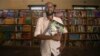 This handout picture taken on Nov. 8, 2023, shows Abdullahi Mire, winner of the U.N. refugee agency's prestigious Nansen Award, posing for a picture in one of the libraries he established in Kenya's Dadaab refugee camp. (AFP Photo/UNHCR)