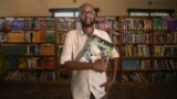 This handout picture taken on Nov. 8, 2023, shows Abdullahi Mire, winner of the U.N. refugee agency's prestigious Nansen Award, posing for a picture in one of the libraries he established in Kenya's Dadaab refugee camp. (AFP Photo/UNHCR)