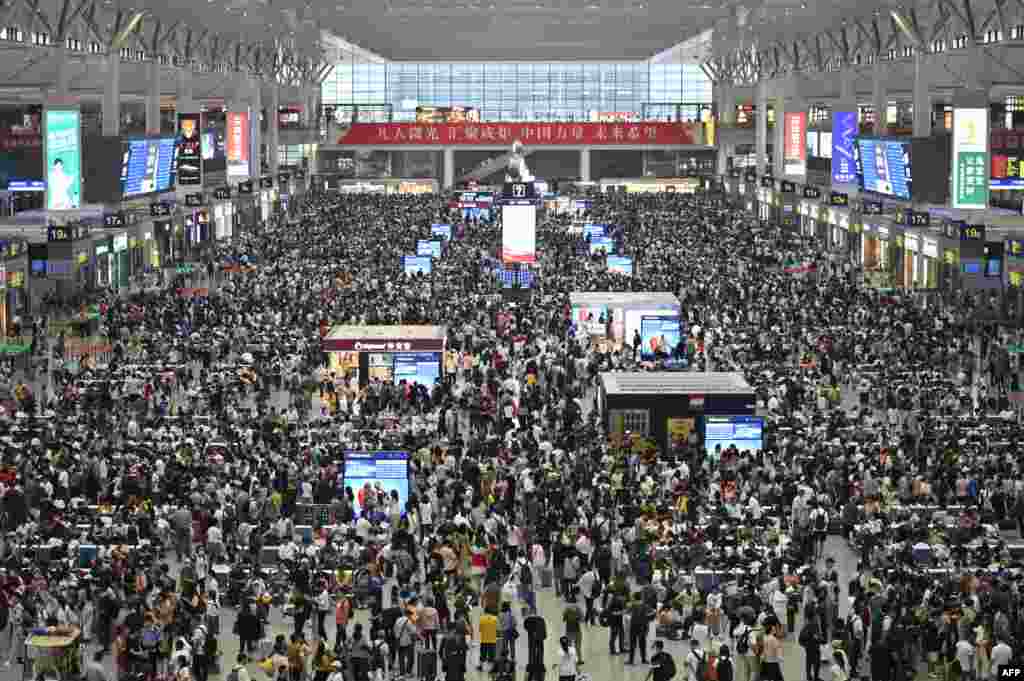 Travelers make their way through the Shanghai Hongqiao railway station in China.