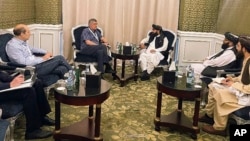 Zabihullah Mujahid of Afghanistan's Taliban government, center right, speaks with Russian envoy Zamir Kabulov in Doha, Qatar, June 30, 2024. The third round of talks on global engagement with the Taliban ended July 1. (Taliban spokesman's office via AP)