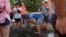 A man refreshes himself at a fountain in Rome, Italy, July 17, 2023. Tourist flock to the eternal city while scorching temperatures grip central Italy with Rome at the top of the red alert list as one of the hottest cities in the country.