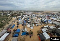 Displaced Palestinians who fled their houses due tor Israeli strikes take shelter in a tent camp in Rafah in the southern Gaza Strip, Feb. 13, 2024.